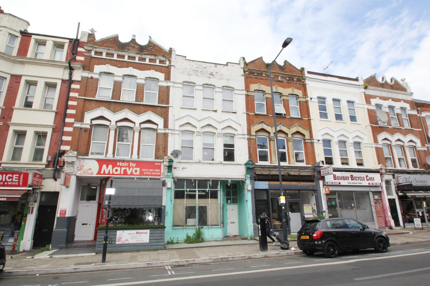 Mid-terrace shop and upper parts in Kilburn